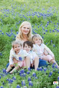 grandmother with grandsons sitting in bluebonnets