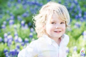 little kid smiling in bluebonnets