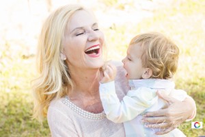 grandmother playing with grandson in bluebonnets